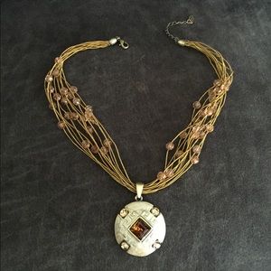 Gold beaded necklace with amber gem medallion